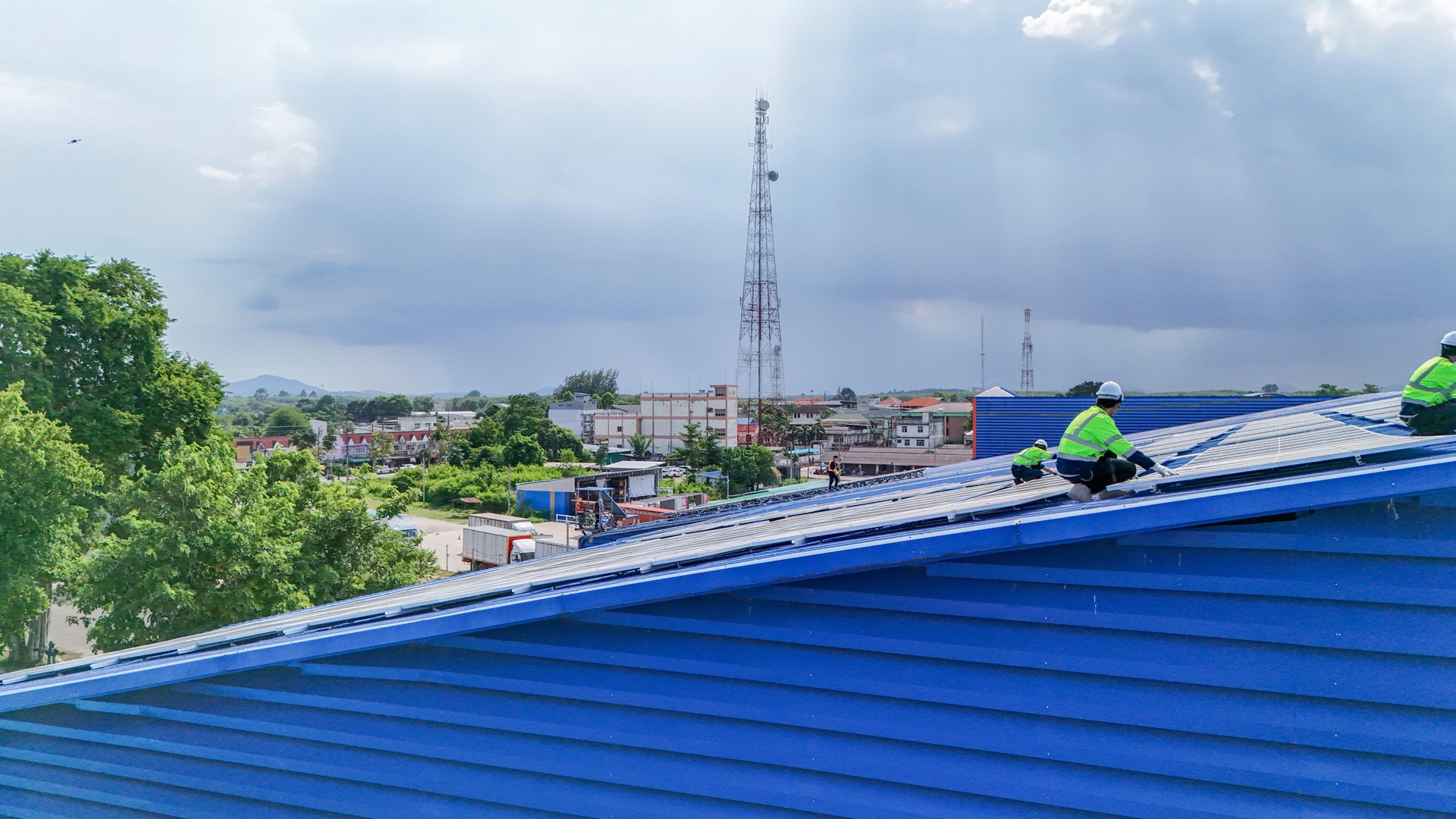 Worker Technicians are working to construct solar panels system on roof. Installing solar photovoltaic panel system. Men technicians walking on roof structure to check photovoltaic solar modules.